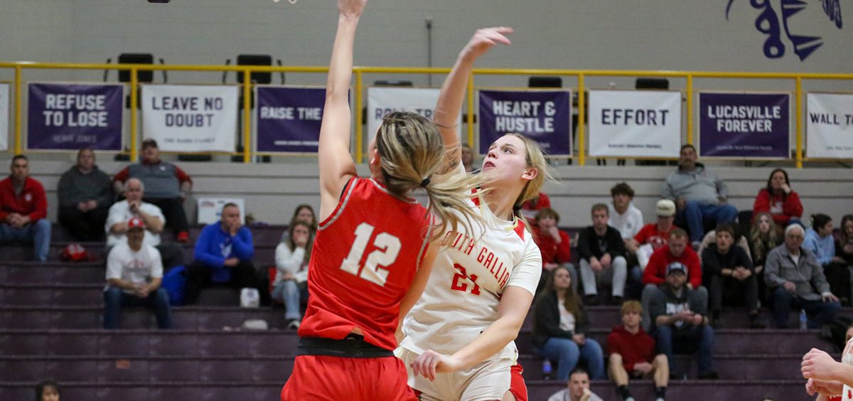 The Lady Tomcat goes up for a layup with a Lady Rebel trying to block her attempt.