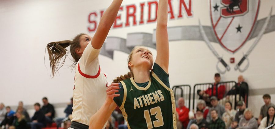 Lex Koopal goes up for a layup with a Sheridan defender trying to block her layup.