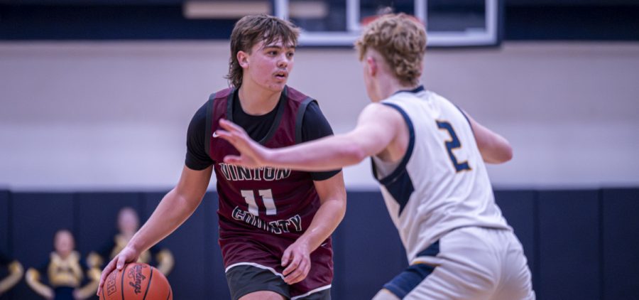 Josh Montgomery looks to pass the ball to a teammate while getting guarded by a Wellston defender.