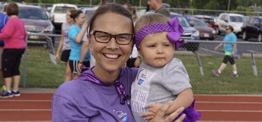 Julie Turner holds a toddler at a charity walk.