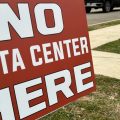Signs opposing a data center north of Ashville, Ohio line the streets of that village.