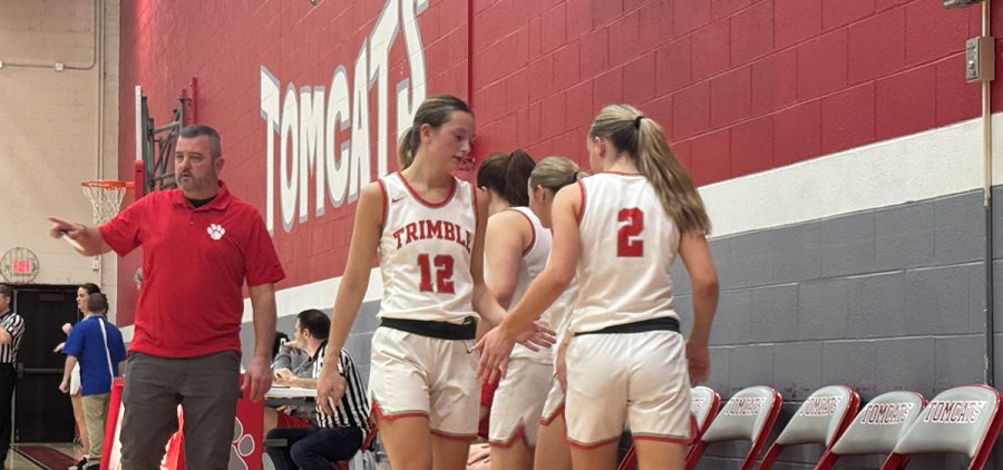 The Lady Tomcats high five their teammate who is subbing out of the game for the moment.