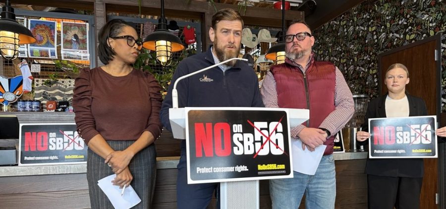Members of Ohioans for Cannabis Choice stand behind a podium.