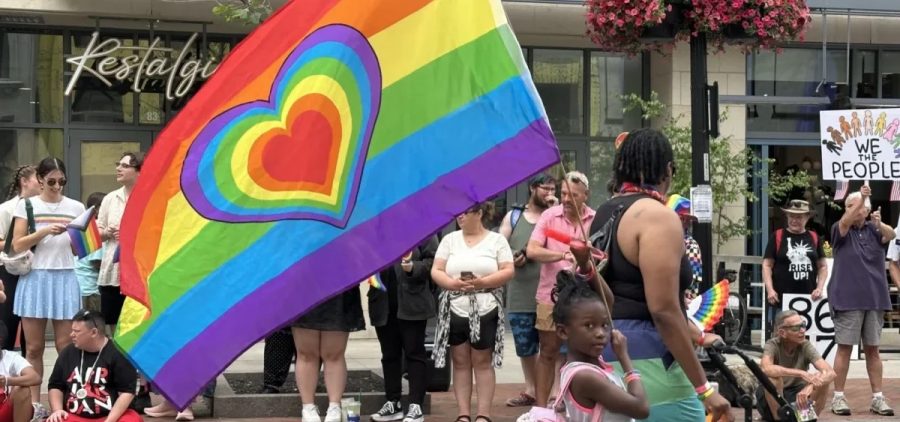 A participant carries a rainbow flag in the Columbus Pride parade on June 14, 2025.