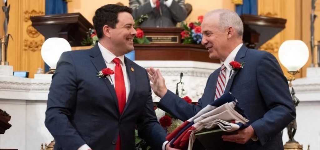 Senate President Rob McColley and House Speaker Matt Huffman stand in front of a joint session of the Ohio legislature.