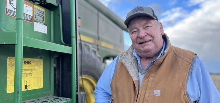 Len Vonderhaar poses next to a giant tractor.