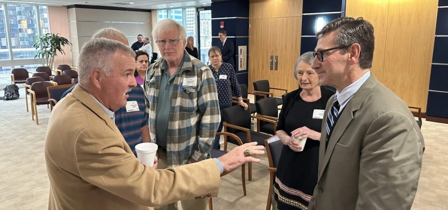 STRS board member Wade Steen (right) talks to retired teachers during a break at the monthly board meeting on May 15, 2024