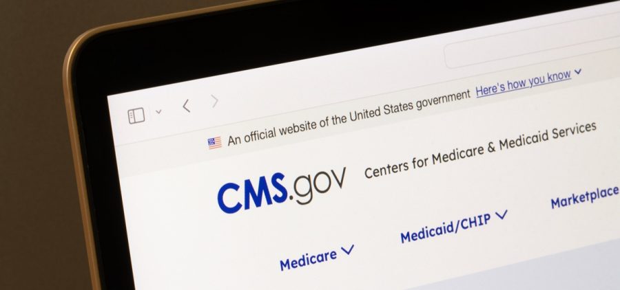 A laptop screen displays the CMS.gov website.