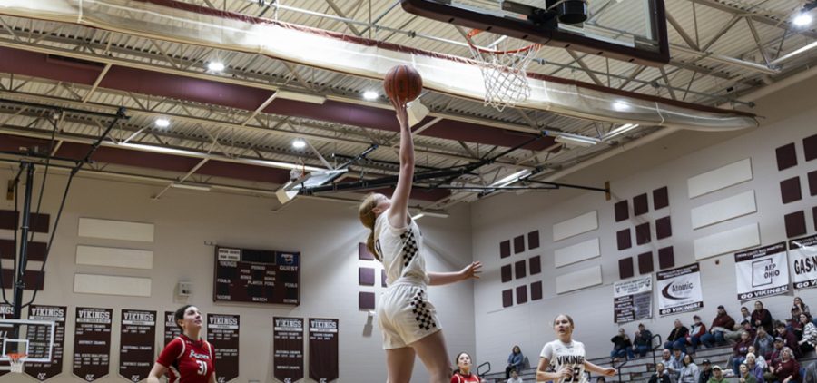 Vinton County Lady Viking goes up with a layup with a Logan Elm Lady Braves defender a few steps behind.