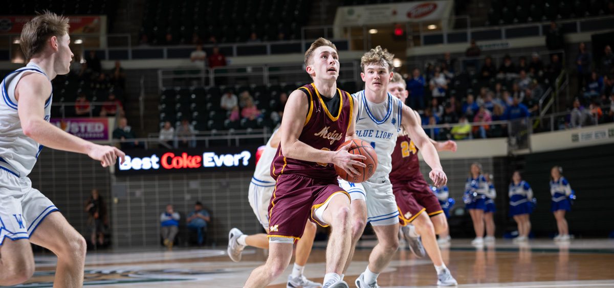 Owen Tracy taking the ball to the hoop in the Convocation Center.