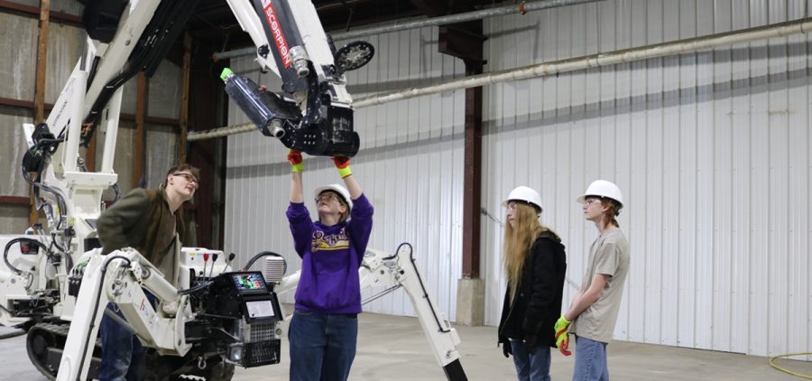 Southern local students learn how to control a 3D printer at Vitruvian's warehouse in Athens.