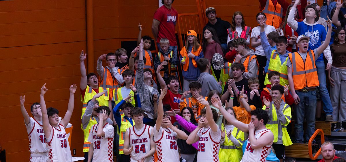 The Peebles bench and student section celebrate a three-pointer against Waterford.