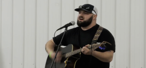 Evan McCune plays guitar and sings at the Shine for the Mine fundraiser