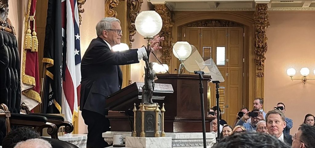Gov. Mike DeWine gestures to state lawmakers assembled for his final State of the State speech.