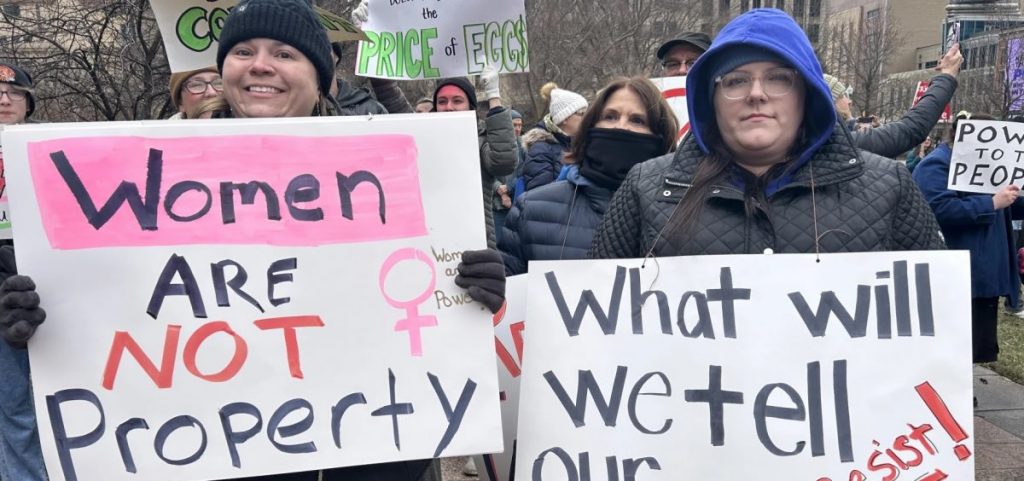 Protestors hold signs promoting women's rights
