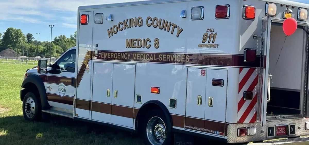An ambulance for Hocking County is parked in the grass.