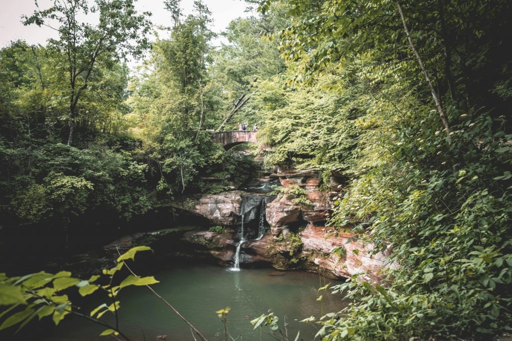A shot of the fall in hocking hills that is under the stone bridge.