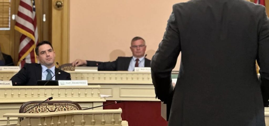 Rep. Steve Demetriou in committee meeting sitting at his desk.