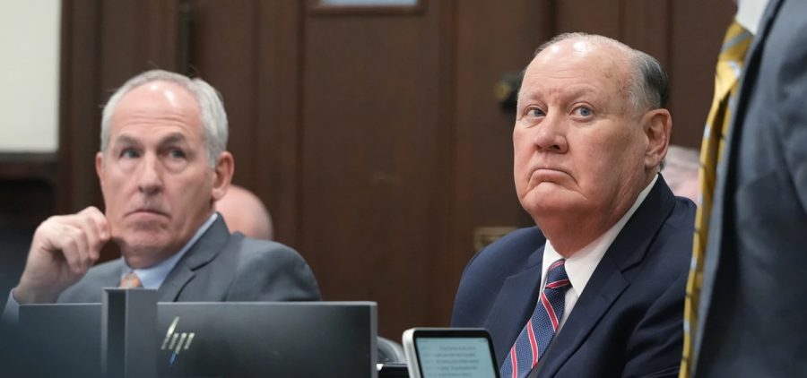 Ex-FirstEnergy Senior Vice President Michael Dowling and former FirstEnergy CEO Chuck Jones look up at Attorney Noah Munyer during their trial in Summit County Common Pleas Judge Susan Baker Ross's courtroom