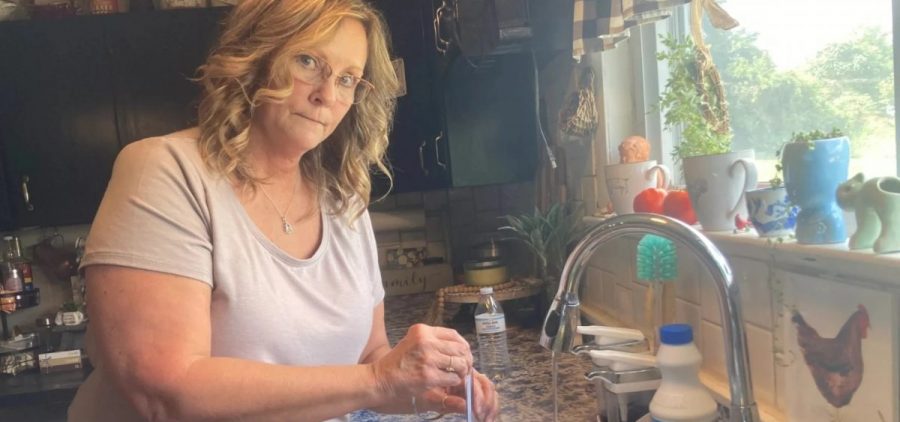 Cadiz resident Stacey Greer tests the pH and other aspects of her tap water
