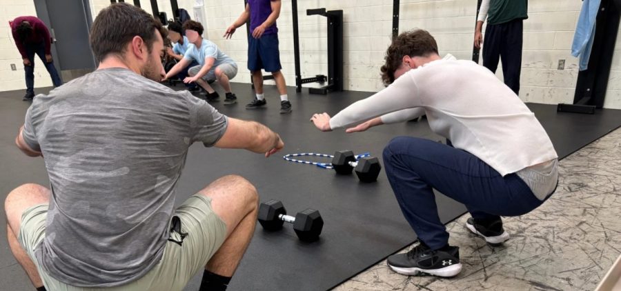 Coach Austin Haines shows correct form to a young participant of Expanding Horizons at the Circleville Juvenile Corrections Facility.