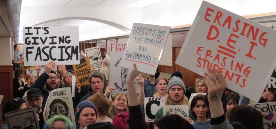 Student protestors pack the hallway outside the University of Cincinnati's Board of Trustees meeting