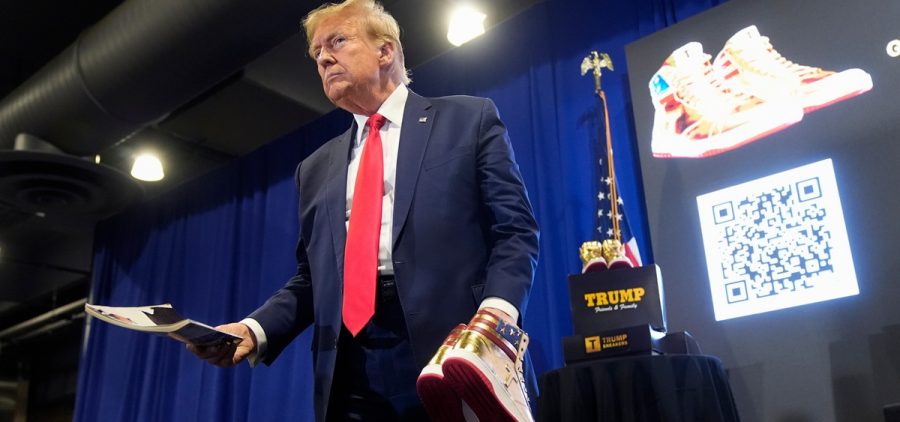 Donald Trump hold a Playboy magazine and gold Trump sneakers at Sneaker Con Philadelphia