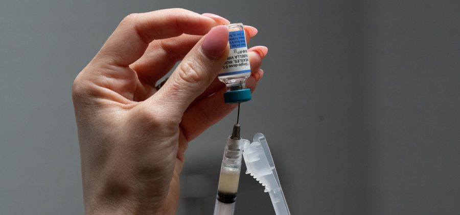 Lauren Ellenburg, a nurse, prepares a combination measles, mumps and rubella vaccine for a 12-month-old