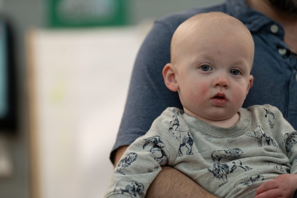 A man holds his toddler son.