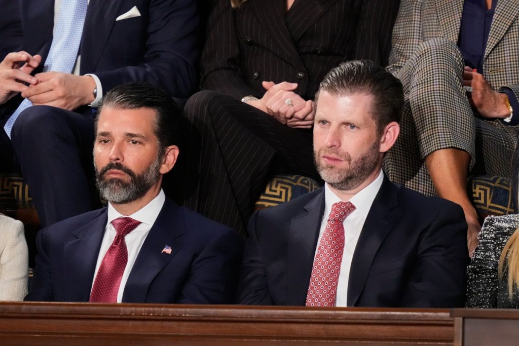 Donald Trump Jr. and Eric Trump listen to President Donald Trump's State of the Union address
