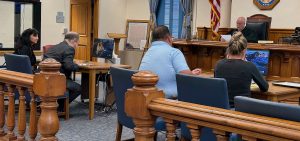 Jean Demosky (left), the executive director of Athens County Job and Family Services, sits with her attorney at her arraignment before Judge George McCarthy in Athens County Court of Common Pleas.