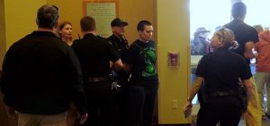 An Ohio University student is arrested outside a meeting of the board of trustees during a demonstration Thursday afternoon.