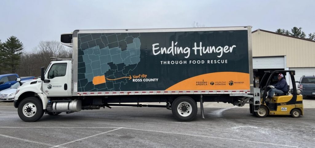 A large truck leaves Brookside Church with a fork lift behind it.