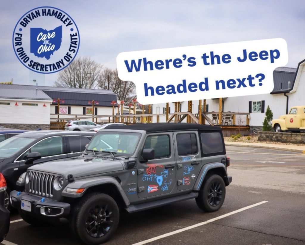A grey Jeep Wrangler with Ohio stickers on it is parked in a parking lot. The photo has text on it that reads "Where's the Jeep headed next?" It also has a logo for Bryan Hambley's Secretary of State's campaign.