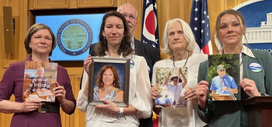 Advocates with Ohio End of Life Options holding photos of loved ones who died of terminal illnesses