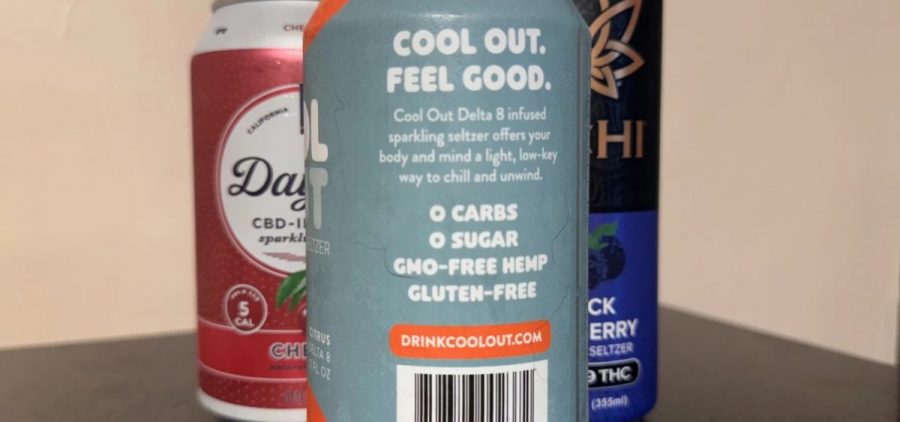 Three cans of hemp-based beverages sit on a table.