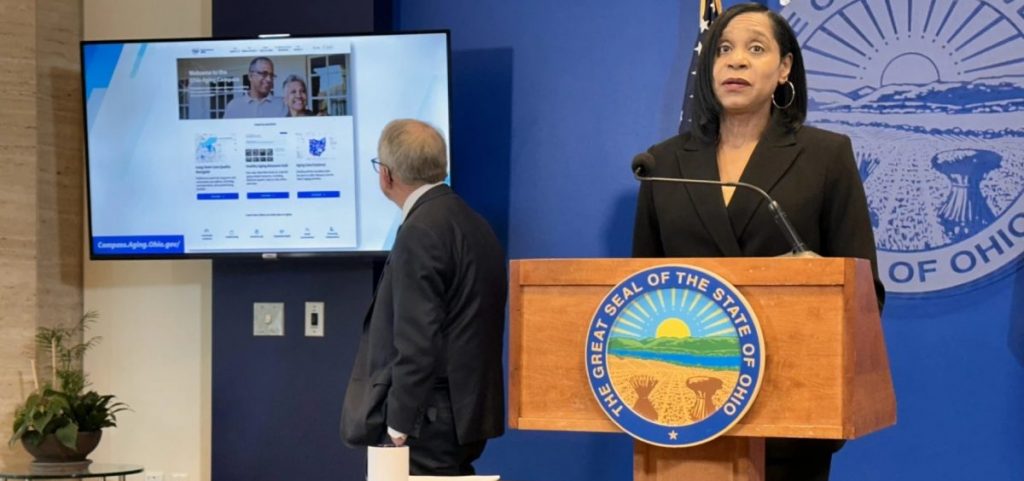 Ohio Department of Aging director Ursel McElroy (center) unveils the Ohio Aging Compass as Gov. Mike DeWine looks at it on a monitor.