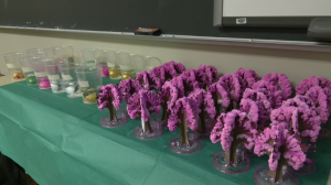 Purple foam tress are arranged on a table at Camp Invention.