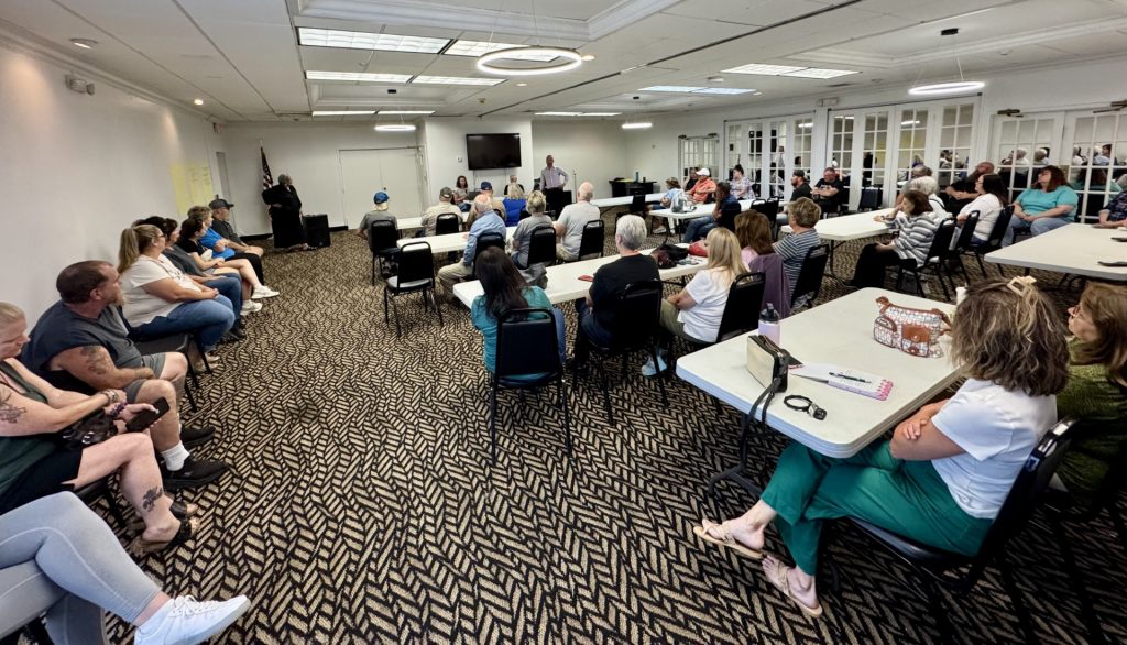 Residents of Guernsey County sit in a meeting room to discuss data centers.