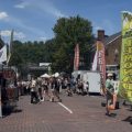 People walk along Court Street as they visit vendors, food trucks and live music performances during Boogie on the Bricks in Athens.