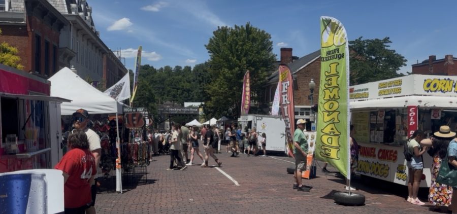 People walk along Court Street as they visit vendors, food trucks and live music performances during Boogie on the Bricks in Athens.