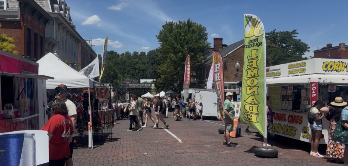 People walk along Court Street as they visit vendors, food trucks and live music performances during Boogie on the Bricks in Athens.