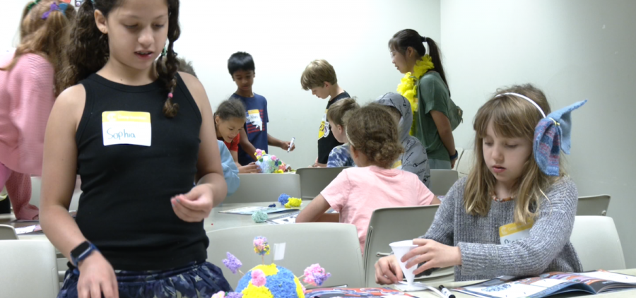 Campers Sophia and Piper play with their exoplanet model for the "Space Morphers" activity.