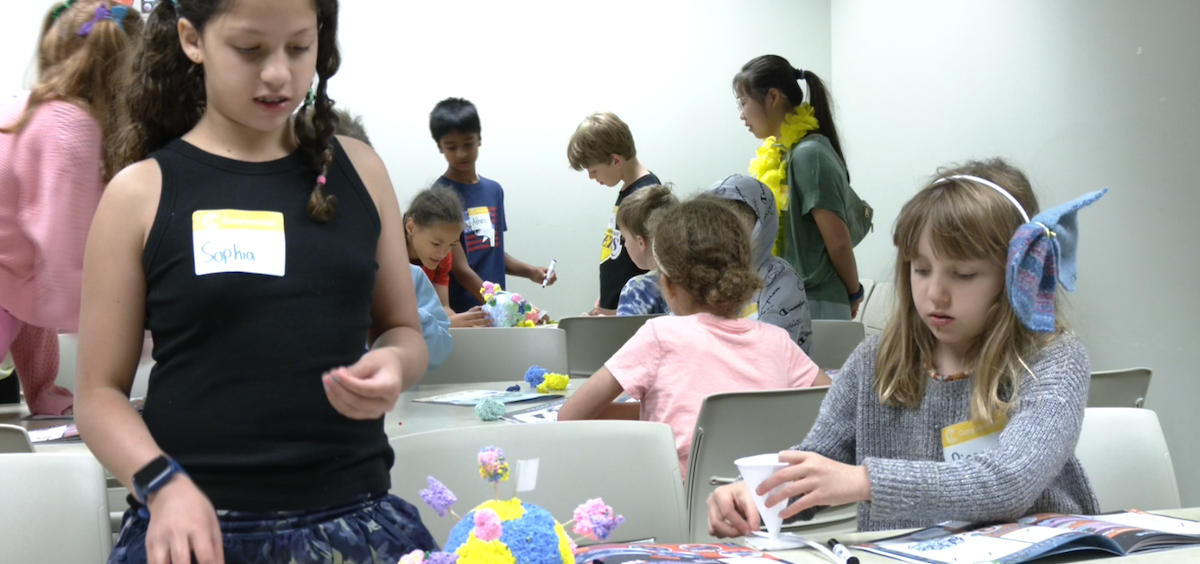 Campers Sophia and Piper play with their exoplanet model for the "Space Morphers" activity.