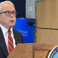 Gov. Mike DeWine stands at a podium.