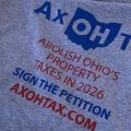 A gray tshirt reads "Ax OH Tax" to promote a constitutional amendment to abolish property tax in Ohio.