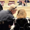 A father and daughter in a wheelchair are among those gathered at the Ohio Statehouse during a hearing on Medicaid reforms at the statehouse.