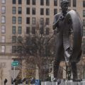 A statue of a man holding a tire is seen in Akron.