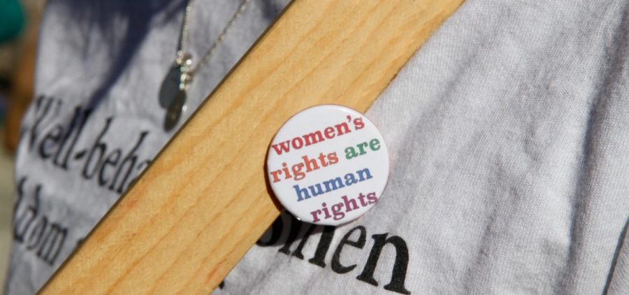 A button at a women's rights march reads women's rights are human rights