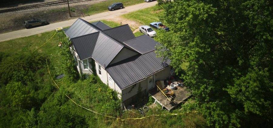 Police tape surrounds a home